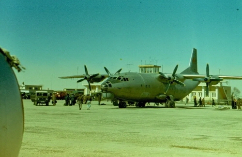 Mazar-i-Sharif airport was built by the United States of America in the early 1960s. The picture shows a Soviet An-12 transport aircraft standing in front of the tower, while the photographer stands next to a MiG-17.