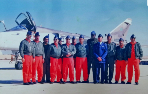 The first eight retrained pilots and weapons navigators at the Ghardabiya airbase in front of their Su-24 bomber aircraft.