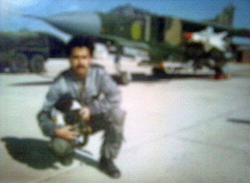 A pilot of the Libyan 1090th Air Squadron and his MiG-23MF Flogger-B fighter jet at the Ghardabiya air base in the 1980s. The MiG-23MF has an unusual dark camouflage pattern for the desert, similar to that of the Czechoslovak MiG-23MFs. It was armed with R-3S Atoll and R-23R Apex missiles. A pilot of the Libyan 1090th Air Squadron and his MiG-23MF Flogger-B fighter jet at the Ghardabiya air base in the 1980s. The MiG-23MF has an unusual dark camouflage pattern for the desert, similar to that of the Czechoslovak MiG-23MFs. It was armed with R-3S Atoll and R-23R Apex missiles.