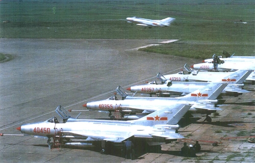 Chinese 44th Air Divisions early J-7II MiG-21 Fishbed and in front of Shenyang J-6 MiG-19 Farmer landing